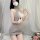 Woman wearing seductive open-front backless knit set with matching sleepwear outfit, featuring a provocative lingerie dress d...