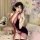Woman in seductive purple cheongsam lingerie with open back, holding parasol on bed. pure-yet-tempting sleepwear set.
