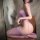 Woman wearing seductive purple fishnet bodystocking, sheer mesh full-body stocking with cutouts, plus size & busty friendly d...