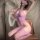 Woman modeling a seductive purple fishnet bodystocking with sheer mesh, cutouts, and strappy neckline.