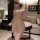 Woman in beige floral qipao lingerie set with sheer fabric, posing elegantly in a luxurious bedroom setting.
