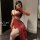 Woman posing in a red seductive lingerie set with sheer gloves and a rose choker, showcasing the pure & tempting sleepwear de...