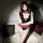 Woman wearing seductive restraint-style lingerie set with leather-look corset, plaid bow and skirt, fishnet stockings.