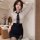 Woman wearing a seductive secretary costume set with a deep v-neck blouse, bodycon skirt, and tie.