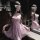 Woman in pink sheer lace sleep dress with underwire, floral details, and blindfold—sexy wife-inspired nightwear.