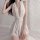Woman wearing a seductive sheer white lingerie set with deep v-neck and lace waistband, perfect for tempting sleepwear.