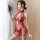 Woman in red sheer lingerie set with floral embroidery, holding a fan; features open-crotch design and cheeky cutout for sedu...