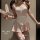 Woman modeling a pink and white seductive sleepwear set with bunny ears headband, featuring a frilly top, apron-style skirt, ...