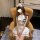Woman in white student-style lingerie set with sailor collar, pleated skirt, and fluffy headband, seated on tan leather chair...