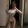 Woman in mirror wearing white lace seductive temptation lingerie set — open-crotch, floral details, sheer panels, qqny sensua...