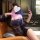 Woman in navy lace lingerie set, posing seductively on leather chair with phone — modest yet alluring sleepwear for intimate ...