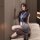 Woman in sleek blue bodysuit and gray skirt, posing on beige couch. sensual air hostess costume set - secretive moonlit lace ...