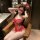 Woman in red lace bunny girl lingerie set with ears and blindfold, seated on leather chair for date night role play.