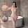 Woman modeling a sensual full-body mesh bodystocking with open-crotch design, sheer seamless lingerie in bathroom setting.
