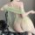 Woman wearing sheer green mesh hanfu lingerie set with open back, designed for roleplay and intimate moments.