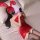 A woman lounges on a bed wearing a red lace bodysuit paired with sheer mesh stockings. she accessorizes with bunny ears and h...