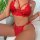 Woman wearing red lace lingerie set with sheer thong and strappy bra, part of the sensual lace bondage-style plus size erotic...