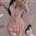 Woman wearing pink sensual lace cake dress lingerie with push-up corset, ruffled skirt, and garter straps.