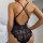Sensual lace bodysuit with deep v-neckline and intricate floral patterns, offering sheer elegance and allure. perfect for int...