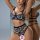 Woman modeling black floral lace two-piece lingerie set with push-up bra and open-crotch panties.
