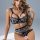 Woman wearing black floral lace push-up bra and open-crotch panties from sensual lace two-piece lingerie set.