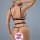 Woman wearing black floral lace two-piece lingerie set with open-crotch design and push-up bra, back view.