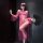 Woman in pink sheer mesh lingerie set with lace, high-end stockings, feather fan, and blindfold – sensual, playful elegance.