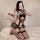 Woman in black lace maid costume with sheer mesh pettiskirt, posing on bed. sensual lingerie outfit with no-remove design.
