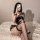 Woman in black lace maid costume with sheer mesh pettiskirt, posing on bed. sensual lingerie outfit, no-remove design.