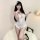 Woman modeling white sensual lace open-crotch bodysuit set - pure & tempting sheer sleepwear for women with feather headpiece...