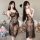 Woman modeling black lace sleep dress with sheer mesh, high slit & backless design – sensual nightgown for women.