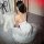 Woman wearing white ice silk cami and shorts set, back view on fluffy rug. sensual lace sleepwear for summer nights.