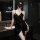 Sensual black satin nightgown with tie-front design and elegant cutouts, perfect for women seeking luxurious sleepwear.