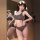 Woman modeling gray lace-trim crop top and high-waisted shorts set with white trim, sporty chic look in mirror selfie.