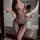 Woman in black lace bodysuit with wine glass, elegant bathroom setting. sensual lingerie sleep set – romantic erotic sleepwea...