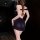 Woman wearing black sensual lingerie with braided hair, back view.