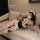 Woman in black and white maid-style lingerie set with garter stockings, lying on sofa – sensual lingerie for women, pure & pl...
