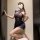 Woman kneeling in a sensual, dark blue lingerie set with sheer panels and ruched detailing, styled as a no-remove seductive u...