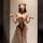 Woman in sensual lingerie set with playful uniform style, featuring lace-up bodice and sheer details.