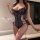 Woman wearing black lace bodysuit with floral patterns and adjustable straps, part of the sensual modest-style lace bodysuit ...