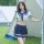 Woman in navy and white sailor-style skirt set with cropped top, standing by tent outdoors. sensual secretarial bodysuit - ai...