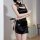 Woman wearing black sheer cheongsam lingerie with high slit, holding decorative sword; elegant sleepwear for small bust.