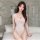 Woman wearing sensual sheer lace bodysuit swimwear, open-crotch one-piece mesh tankini set for adults, in modern bedroom sett...