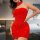 Woman wearing a red, sparkly, strapless mini dress with a matching choker, posing in a bedroom.
