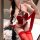 Woman wearing red embroidered doudou set with lace-up bodice, sheer panels, and matching thigh-highs.