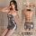 Woman modeling a shiny silver backless halter sleepwear set with crisscross straps and a form-fitting club skirt.