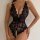 Woman wearing a black lace bodysuit with scalloped edges and a halter neckline.