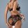 Woman wearing black floral sheer lace lingerie set with babydoll top and garter belt, showcasing soft, seductive design.