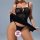 Woman wearing a sexy black sheer lace chemise with floral cut-out details and mesh fabric, showcasing seductive sleepwear des...