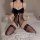 Woman wearing sexy bow lace french lingerie set with sheer mesh bodysuit, cut-out details, and elegant embellishment on bed.
